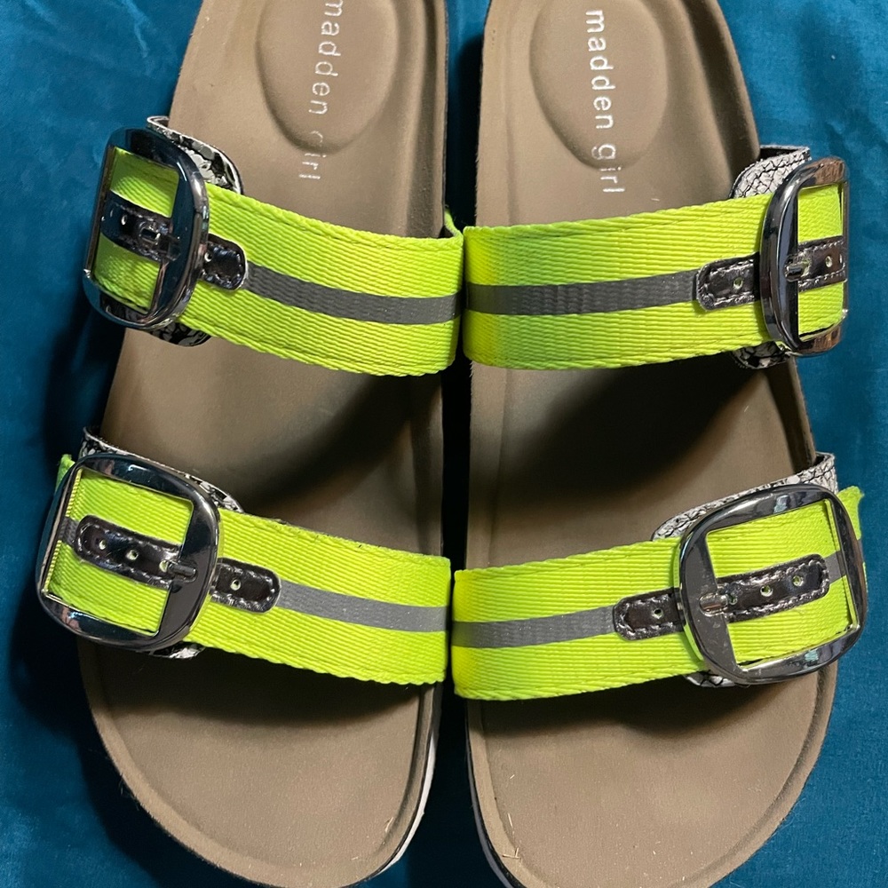 Like green and silver buckled slides.